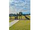 Community playground with playset, slide, and walking path at 1625 Hill Park Dr, Deltona, FL 32725