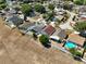 Aerial view of the house with its backyard, neighboring houses, and neighborhood streets at 1804 Westminster Trl, Clermont, FL 34714