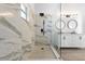 A modern bathroom with a spacious walk-in shower and double vanity at 1804 Westminster Trl, Clermont, FL 34714