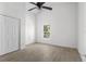 Bright bedroom with light wood-look floors, ceiling fan, and closet at 1804 Westminster Trl, Clermont, FL 34714