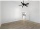 A bright, minimalist bedroom that leads into a stylish white kitchen at 1804 Westminster Trl, Clermont, FL 34714