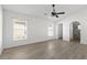 An airy room with an arched doorway that leads to a modern bathroom at 1804 Westminster Trl, Clermont, FL 34714