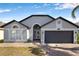 Charming single-story home featuring a two-car garage and brick-paved walkway under a clear, blue sky at 1804 Westminster Trl, Clermont, FL 34714