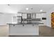 Kitchen with a large island, stainless appliances, a stylish backsplash, and lots of natural light at 1804 Westminster Trl, Clermont, FL 34714