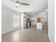 Well-lit kitchen featuring stainless appliances, an island, and modern accents in an open layout at 1804 Westminster Trl, Clermont, FL 34714