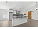 Bright kitchen features an island, stainless steel appliances, white cabinets, and modern finishes at 1804 Westminster Trl, Clermont, FL 34714