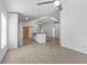 Open floor plan featuring a kitchen with an island and stylish barn doors leading to a bright living area at 1804 Westminster Trl, Clermont, FL 34714