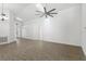 Bright, open-concept living room with light wood-look flooring and a modern ceiling fan at 1804 Westminster Trl, Clermont, FL 34714