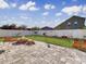 Landscaped backyard with fire pit and patio area at 1850 Patriot Way, Saint Cloud, FL 34769