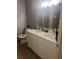 Double vanity bathroom with modern white cabinets and quartz countertop at 1850 Patriot Way, Saint Cloud, FL 34769