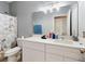 Clean bathroom with white vanity, large mirror and shower at 1850 Patriot Way, Saint Cloud, FL 34769