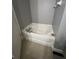 Oval bathtub with modern faucet and neutral color palette at 1850 Patriot Way, Saint Cloud, FL 34769