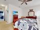 Main bedroom with large bed, dresser, TV and view of kitchen at 1850 Patriot Way, Saint Cloud, FL 34769