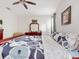 Main bedroom with a large bed, dresser, and ceiling fan at 1850 Patriot Way, Saint Cloud, FL 34769