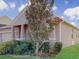 One-story home with a tree and landscaping in front of the house at 1850 Patriot Way, Saint Cloud, FL 34769