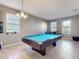 Bright game room with pool table and light-colored flooring at 1850 Patriot Way, Saint Cloud, FL 34769