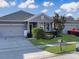 Two-car garage and front yard landscaping at 1850 Patriot Way, Saint Cloud, FL 34769
