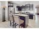 Kitchen with dark cabinets, granite countertops and island at 1850 Patriot Way, Saint Cloud, FL 34769