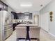 Modern kitchen with island, dark cabinets and stainless steel appliances at 1850 Patriot Way, Saint Cloud, FL 34769