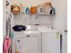 Laundry room with washer, dryer, and shelving for storage at 1850 Patriot Way, Saint Cloud, FL 34769