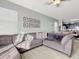 Spacious living room boasts an L-shaped sofa and large windows at 1850 Patriot Way, Saint Cloud, FL 34769