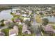 Aerial view showcasing homes surrounding a tranquil lake in a residential community at 243 New River Dr, Kissimmee, FL 34759