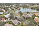 Aerial view of homes nestled around a serene lake with mature trees at 243 New River Dr, Kissimmee, FL 34759