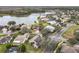Aerial view of a residential community with lake access and lush landscaping at 243 New River Dr, Kissimmee, FL 34759