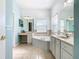 Bathroom boasts a corner tub, double vanity, and ample storage at 243 New River Dr, Kissimmee, FL 34759
