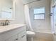 Clean bathroom with white vanity, tub, and shower at 243 New River Dr, Kissimmee, FL 34759