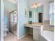 Main bathroom with double vanity, walk-in shower, and updated finishes at 243 New River Dr, Kissimmee, FL 34759