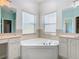 Large bathroom with corner soaking tub, double vanity, and updated fixtures at 243 New River Dr, Kissimmee, FL 34759