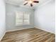 Serene bedroom with wood-look floors and window with shutters at 243 New River Dr, Kissimmee, FL 34759