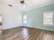 Well-lit bedroom with wood-look floors and a neutral color palette at 243 New River Dr, Kissimmee, FL 34759