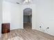 Spacious bedroom with wood-look floors and arched doorway at 243 New River Dr, Kissimmee, FL 34759