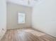 Simple bedroom with wood-look floors and window with shutters at 243 New River Dr, Kissimmee, FL 34759