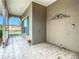 Covered porch with tile floor and green shutters at 243 New River Dr, Kissimmee, FL 34759