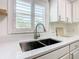 Modern kitchen sink with white quartz countertop and stainless steel faucet at 243 New River Dr, Kissimmee, FL 34759