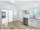 Modern kitchen with white cabinets, stainless steel appliances, and wood-look floors at 243 New River Dr, Kissimmee, FL 34759