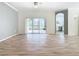 Bright living room featuring hardwood floors and sliding glass doors to backyard at 243 New River Dr, Kissimmee, FL 34759