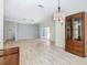 Open living room and dining area with wood-look floors at 243 New River Dr, Kissimmee, FL 34759