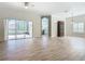 Spacious living area with wood-look floors and sliding doors at 243 New River Dr, Kissimmee, FL 34759