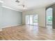 Bright living room featuring hardwood floors and sliding glass doors to backyard at 243 New River Dr, Kissimmee, FL 34759