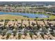 Aerial view of community with houses and a golf course at 2448 Palm Tree Dr, Kissimmee, FL 34759