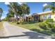 Landscaped grounds with paved pathway and tropical foliage at 2448 Palm Tree Dr, Kissimmee, FL 34759
