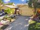 Nice yellow house with a landscaped yard and paver driveway at 2448 Palm Tree Dr, Kissimmee, FL 34759