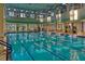 Indoor swimming pool with lanes and large windows at 2448 Palm Tree Dr, Kissimmee, FL 34759