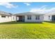 Backyard view of home with grassy lawn at 2756 Greenlands St, St Cloud, FL 34772