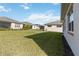 Backyard view of home with grassy lawn and trees at 2756 Greenlands St, Saint Cloud, FL 34772