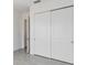 Bedroom with tile floor,door to hallway and double door closet at 2756 Greenlands St, St Cloud, FL 34772